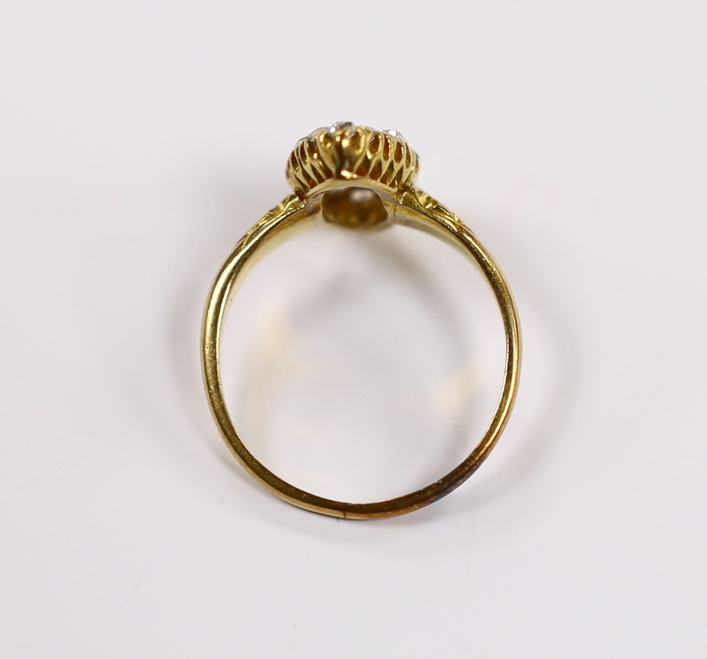 An early 20th century yellow metal and old round cut diamond cluster set marquise shaped ring, size O, gross weight 3.3 grams.